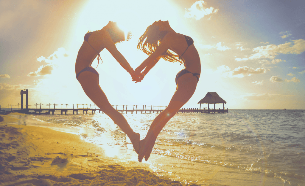 two girls forming a heart