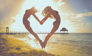 two girls forming a heart
